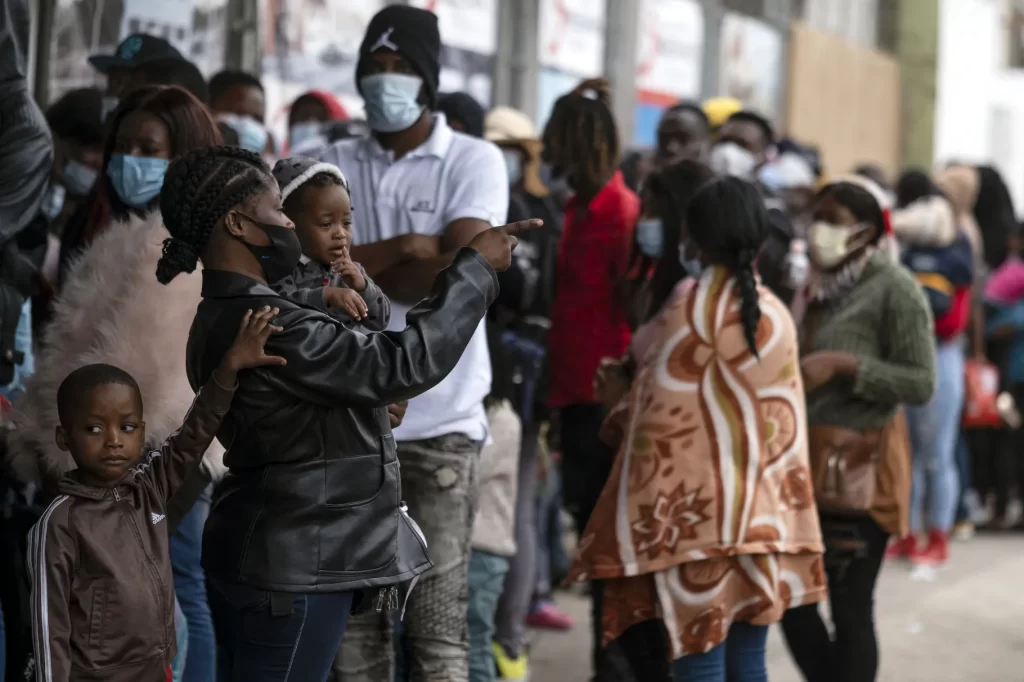 Haitian migrants seeking asylum queue to register with the National Commission for Refugees in Tijuana, Mexico
